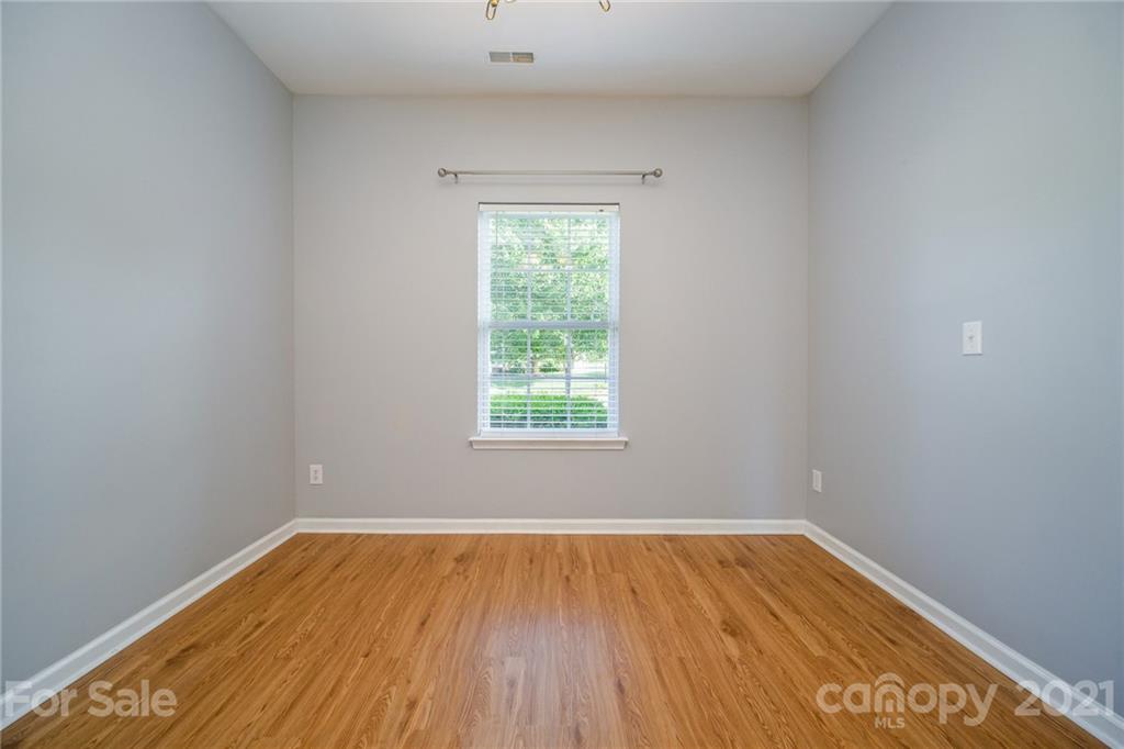 141 Rhyne Springs Road Mount Holly, NC 28120 - Photo 11 of 17 wooden floor in an empty room with a window