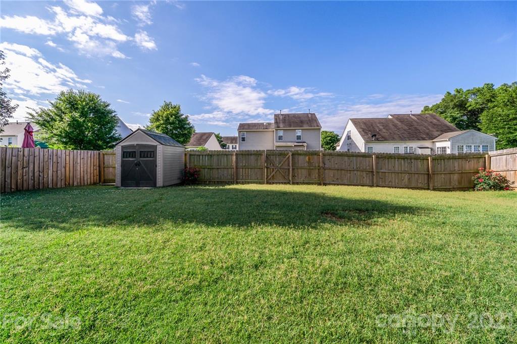 141 Rhyne Springs Road Mount Holly, NC 28120 - Photo 6 of 17 a view of a house with a big yard and large trees