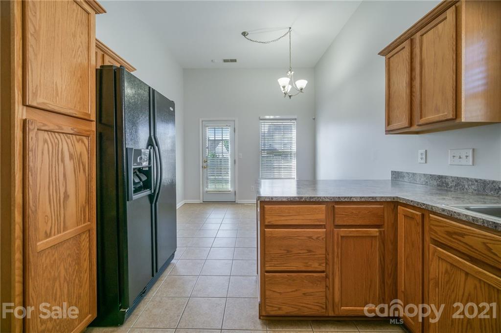 141 Rhyne Springs Road Mount Holly, NC 28120 - Photo 7 of 17 a kitchen with stainless steel appliances granite countertop a refrigerator and a sink