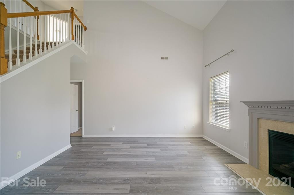 141 Rhyne Springs Road Mount Holly, NC 28120 - Photo 9 of 17 a view of an empty room with wooden floor and a window