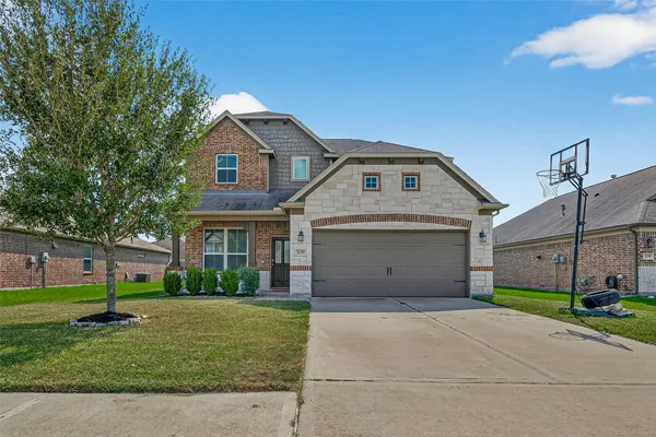 a front view of a house with a yard and garage