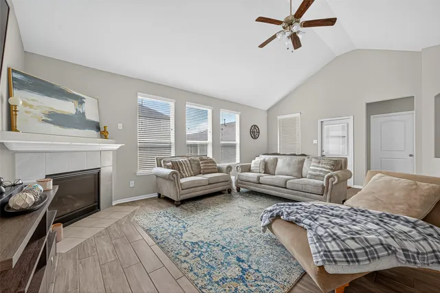 a living room with furniture and a fireplace