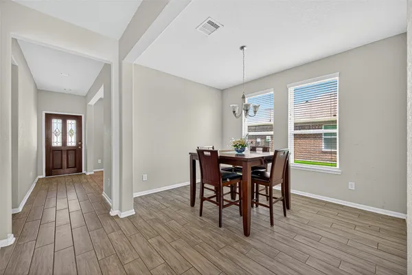 a view of a dining room with furniture and wooden floor