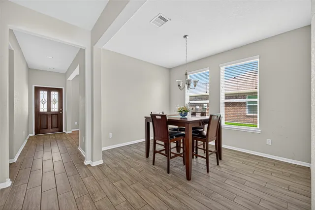 a view of a dining room with furniture and wooden floor