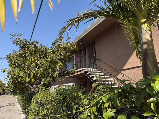 a view of a house with a tree