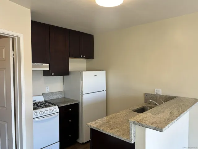 a kitchen with a sink a stove and refrigerator