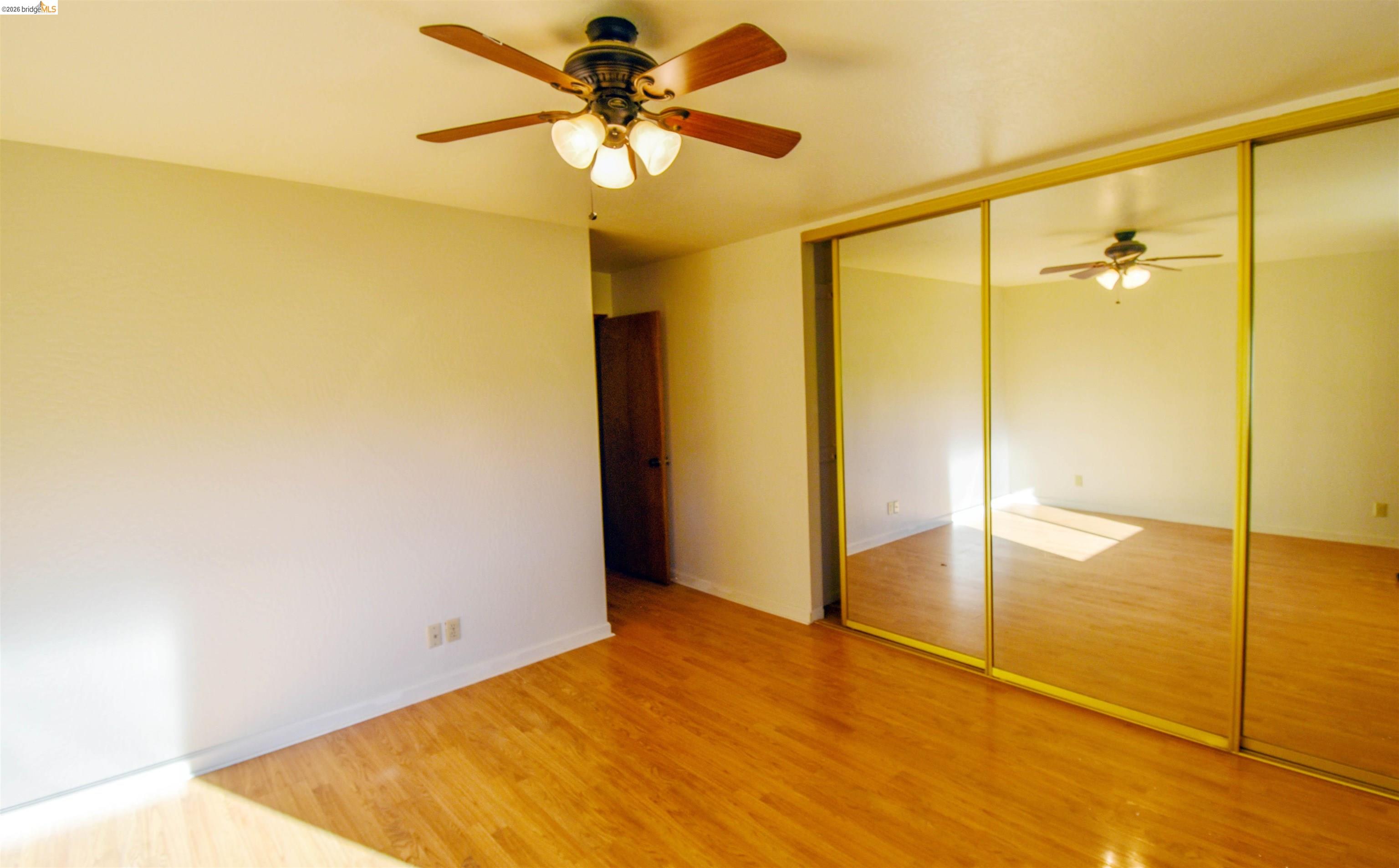 23685 Marble Quarry Road, Unit 22 Columbia, CA 95310 - Photo 13 of 33 Unfurnished bedroom with a closet, light wood finished floors, and ceiling fan