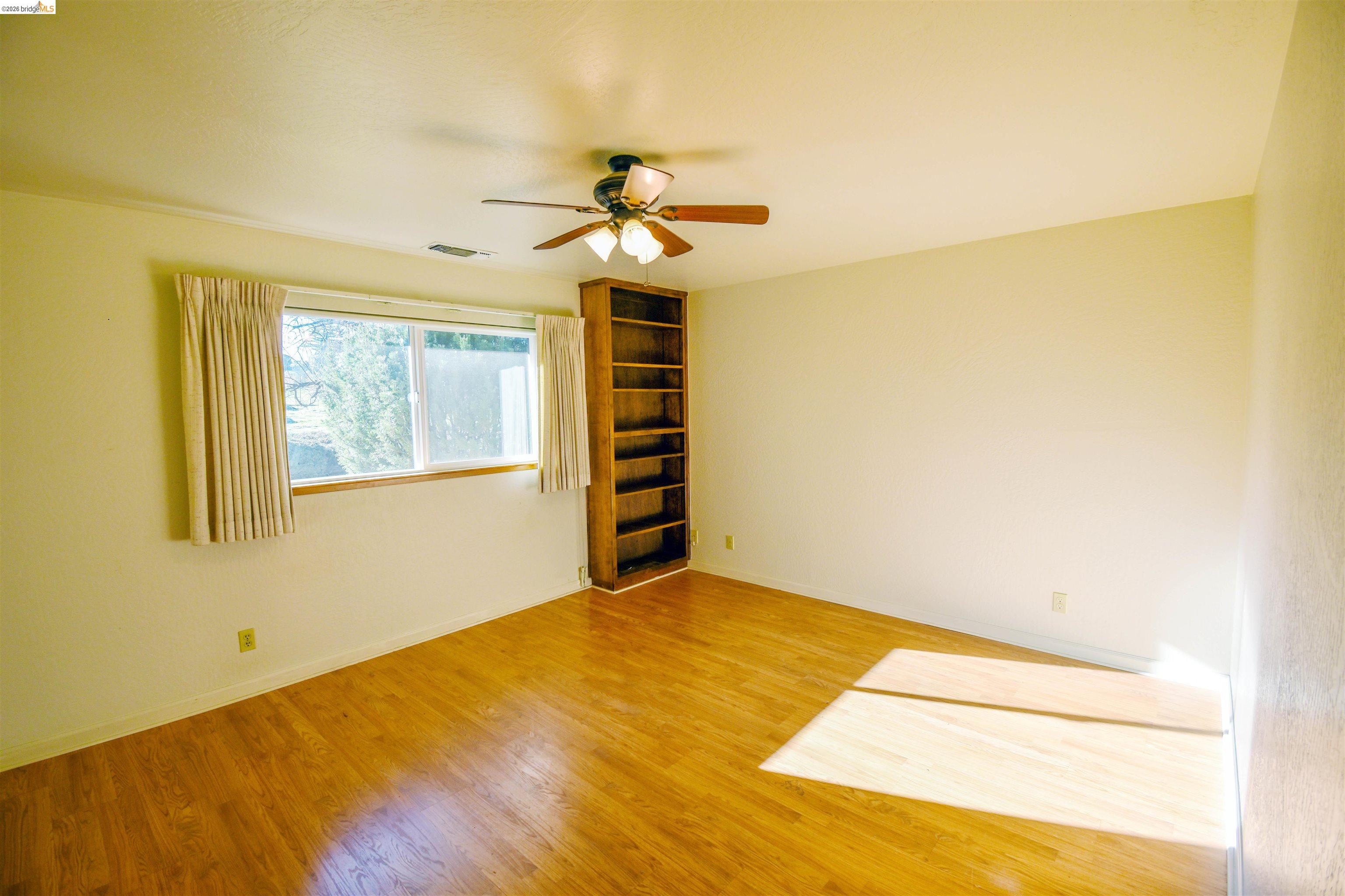23685 Marble Quarry Road, Unit 22 Columbia, CA 95310 - Photo 14 of 33 Unfurnished room featuring ceiling fan and light wood finished floors
