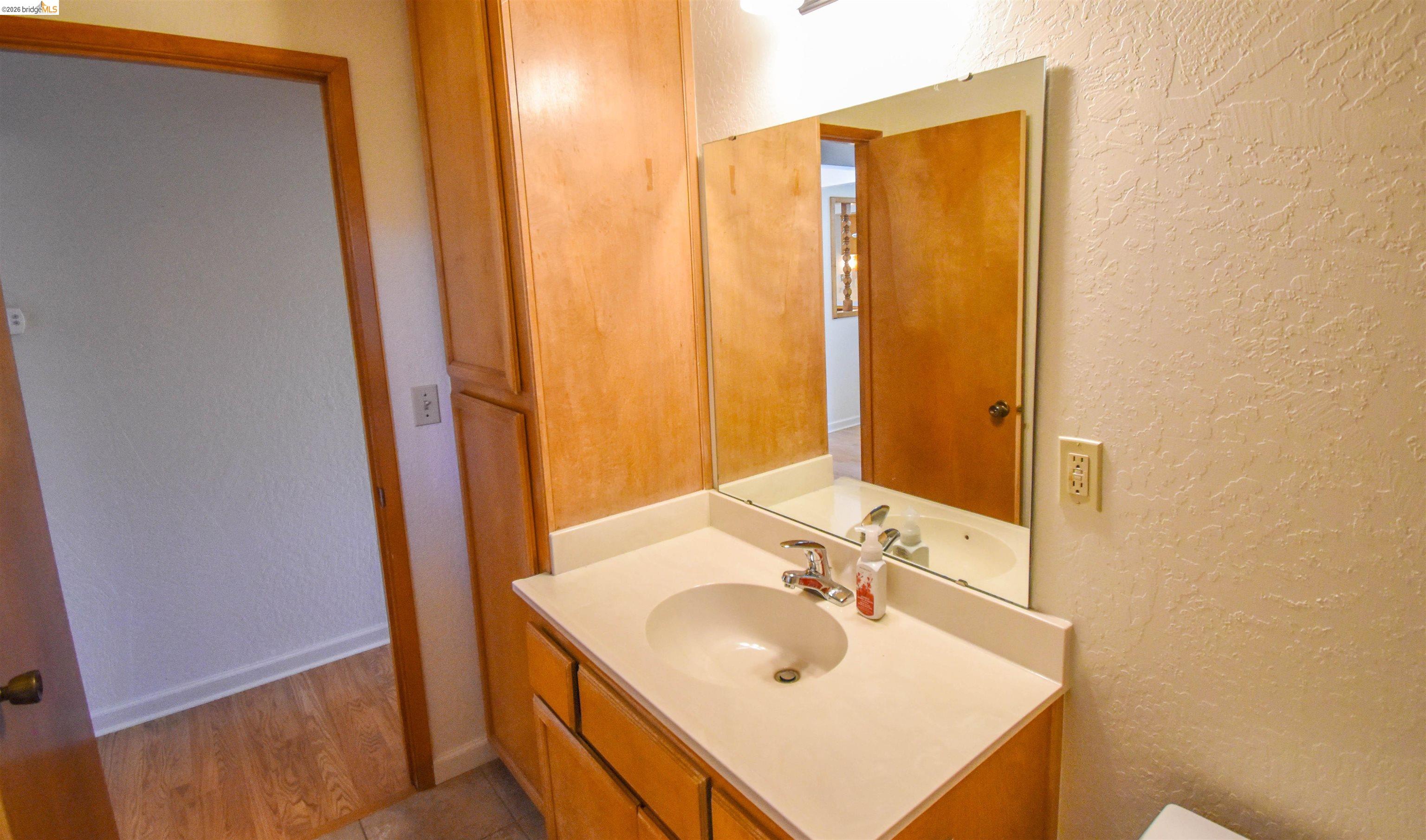 23685 Marble Quarry Road, Unit 22 Columbia, CA 95310 - Photo 20 of 33 Bathroom with a textured wall and vanity