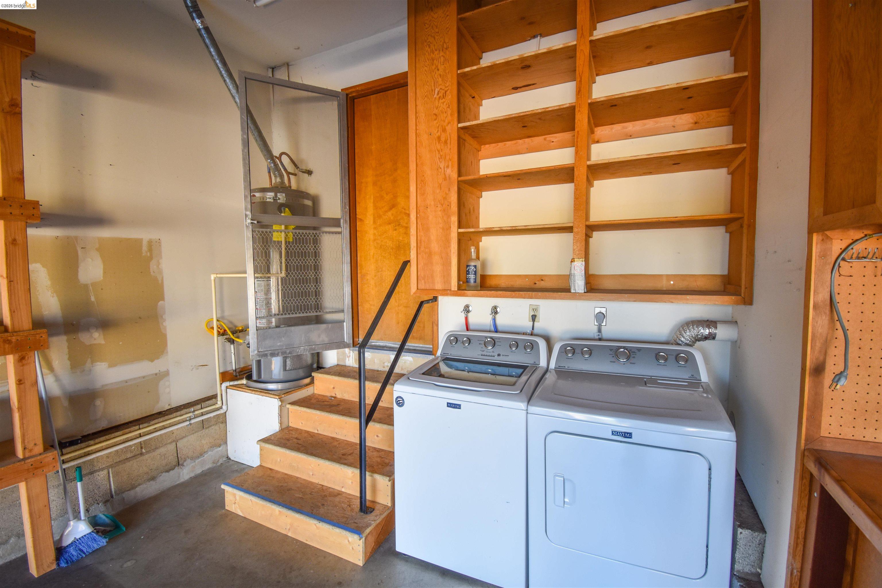 23685 Marble Quarry Road, Unit 22 Columbia, CA 95310 - Photo 31 of 33 Laundry area with water heater, concrete floors, and washer and dryer