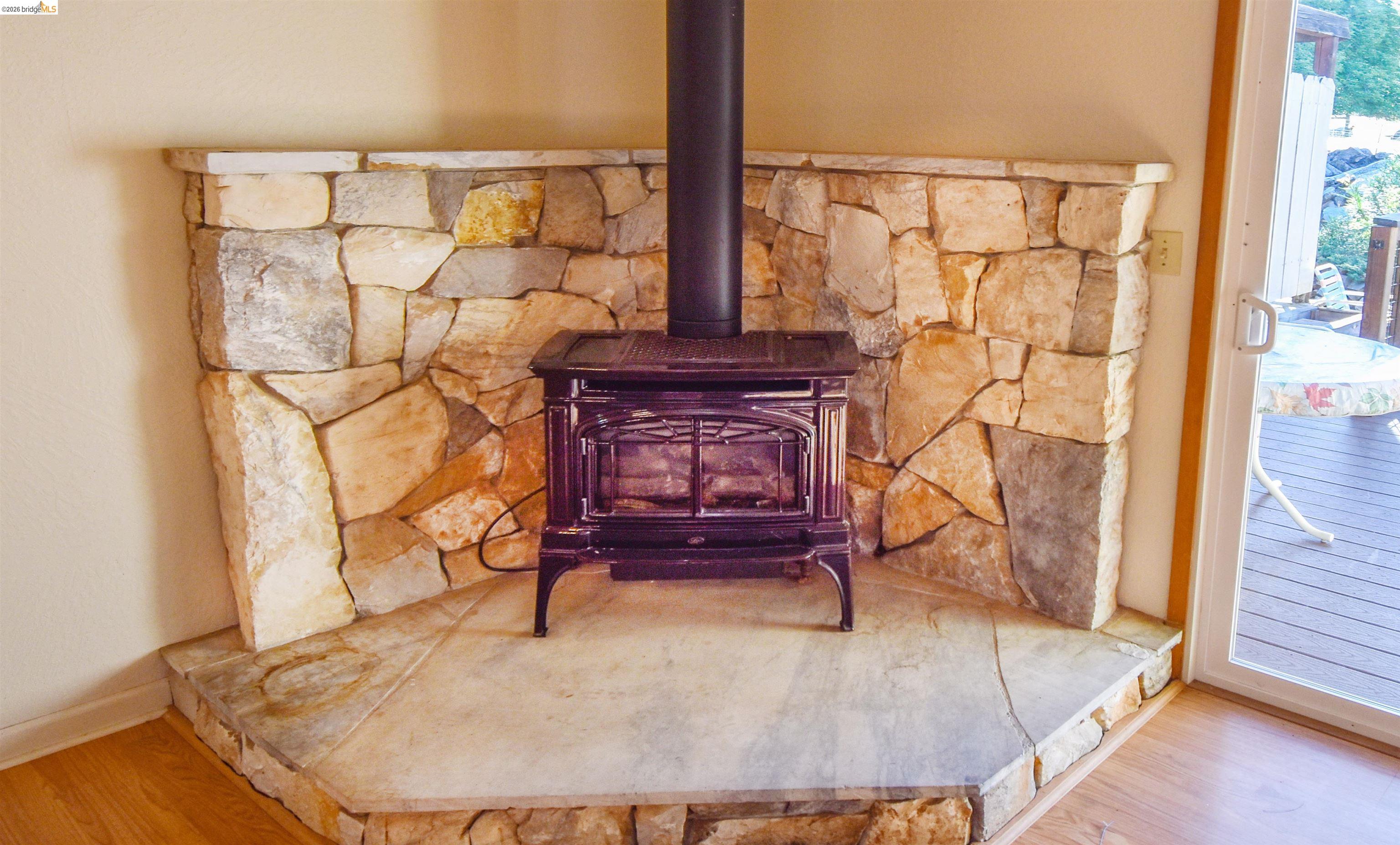23685 Marble Quarry Road, Unit 22 Columbia, CA 95310 - Photo 6 of 33 Detailed view of a wood stove and wood finished floors