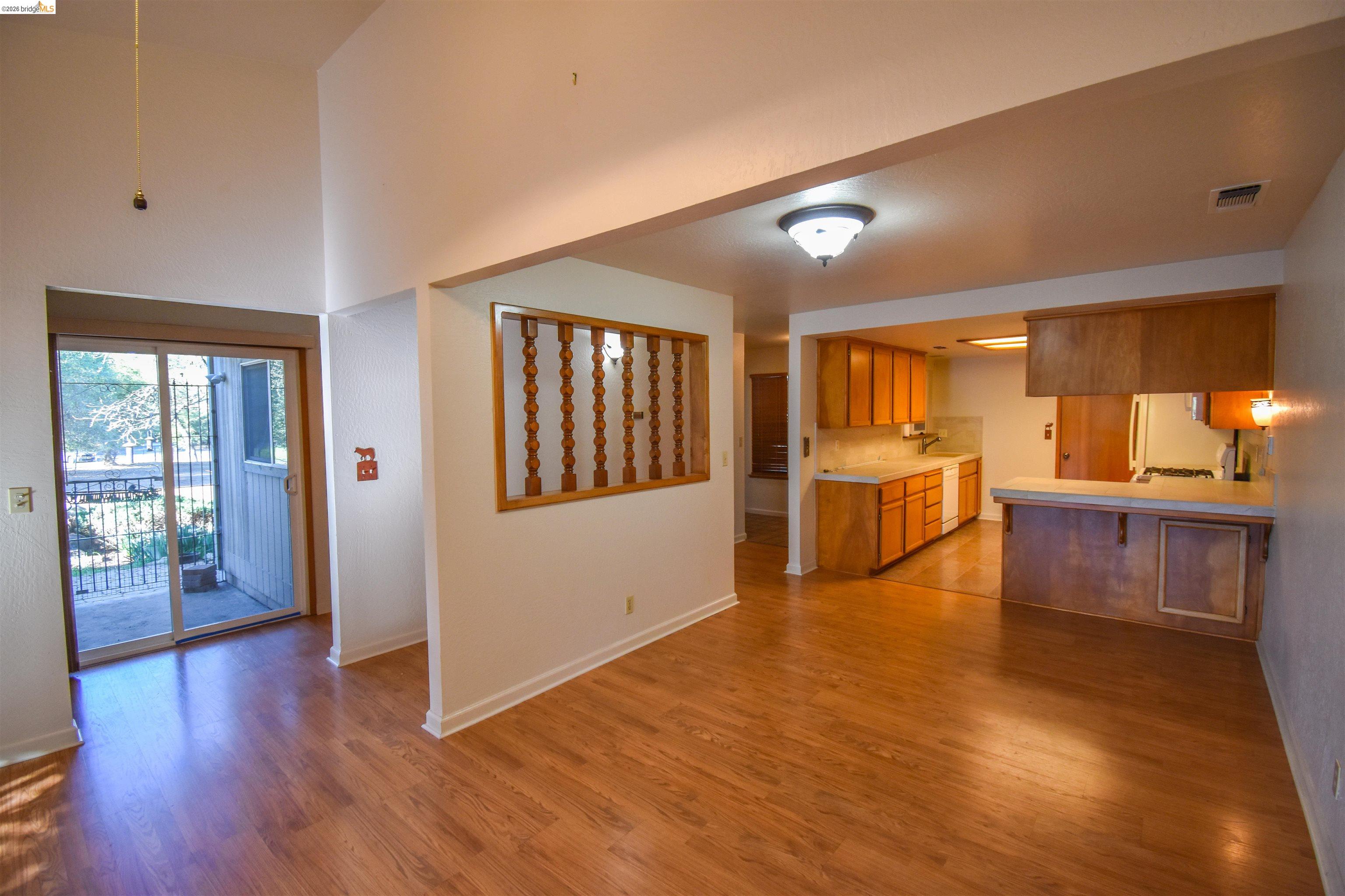 23685 Marble Quarry Road, Unit 22 Columbia, CA 95310 - Photo 7 of 33 Kitchen featuring light countertops, wood finish cabinets, light wood-type flooring, and a peninsula