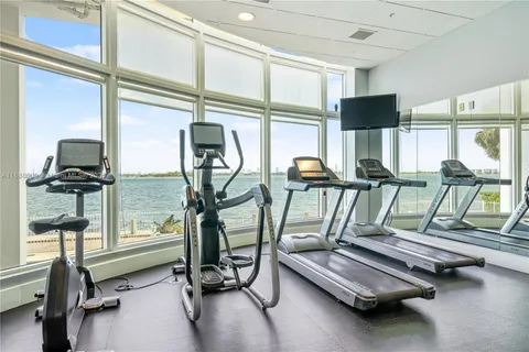 a reading room with furniture and floor to ceiling window
