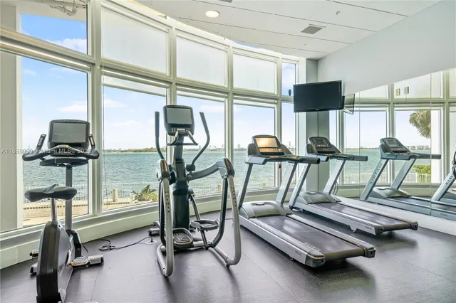 a reading room with furniture and floor to ceiling window