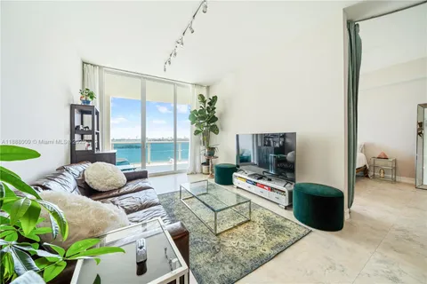 a living room with furniture rug and a flat screen tv