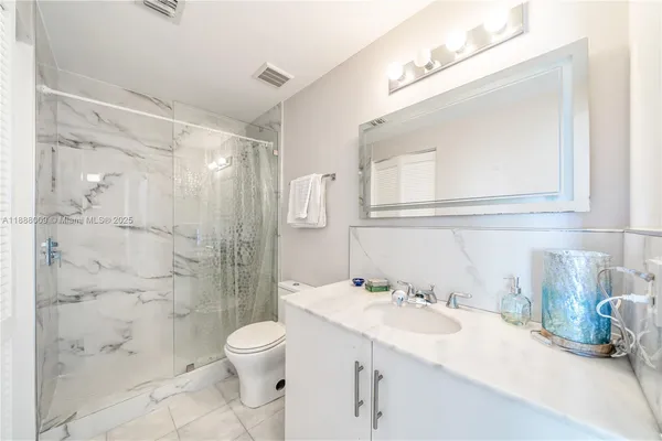 a bathroom with a sink toilet and shower