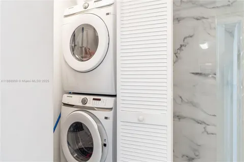 a view of a hallway with washer and dryer