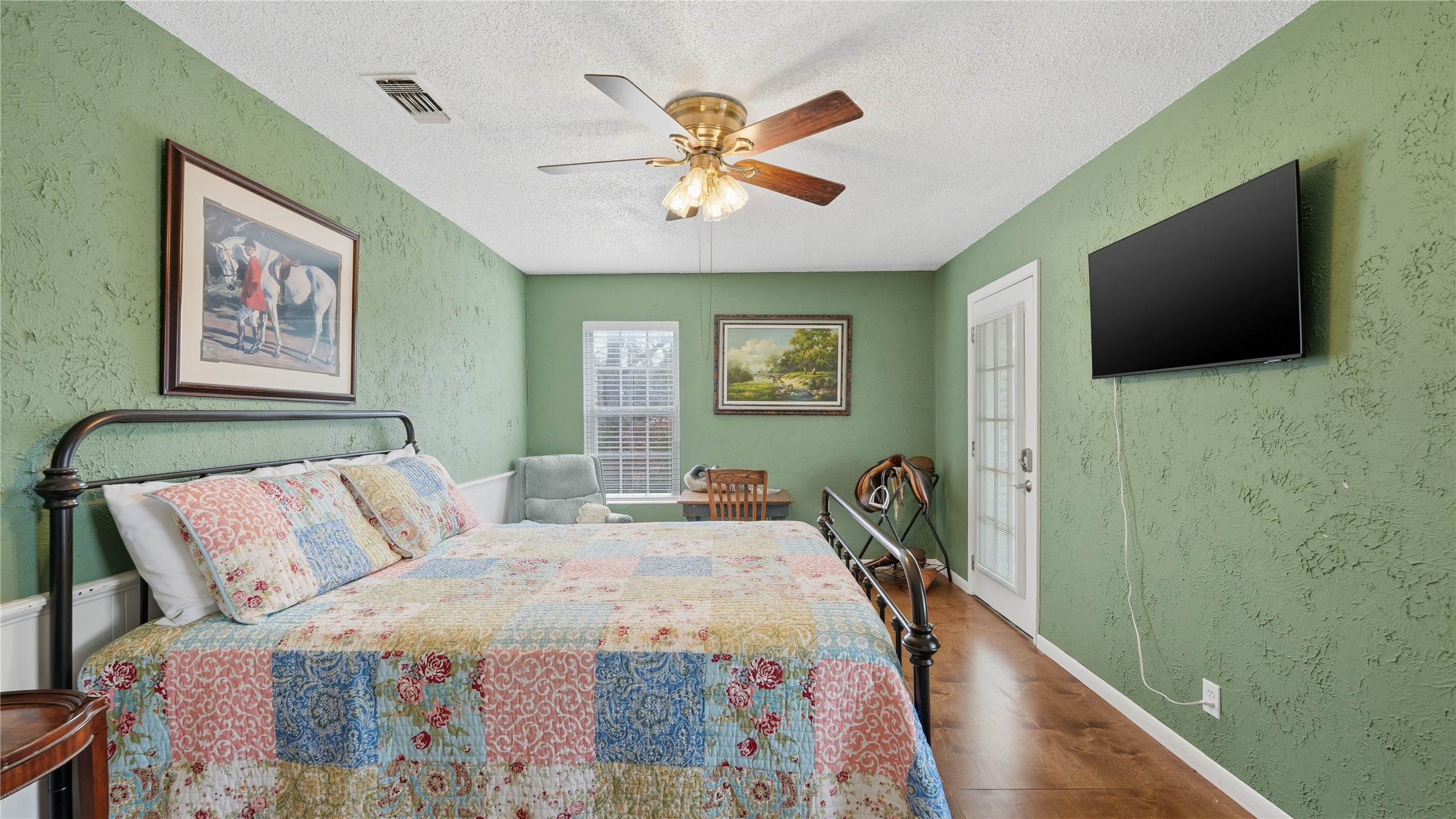 182 Little Ranch Road Red Rock, TX 78662 - Photo 26 of 40 Bedroom with wood finished floors, a textured ceiling, and a ceiling fan