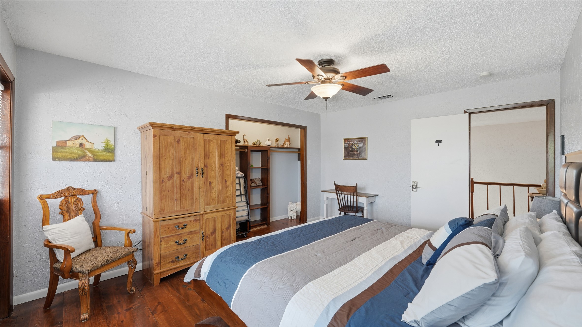 182 Little Ranch Road Red Rock, TX 78662 - Photo 27 of 40 Bedroom with a closet, dark wood finished floors, and a ceiling fan