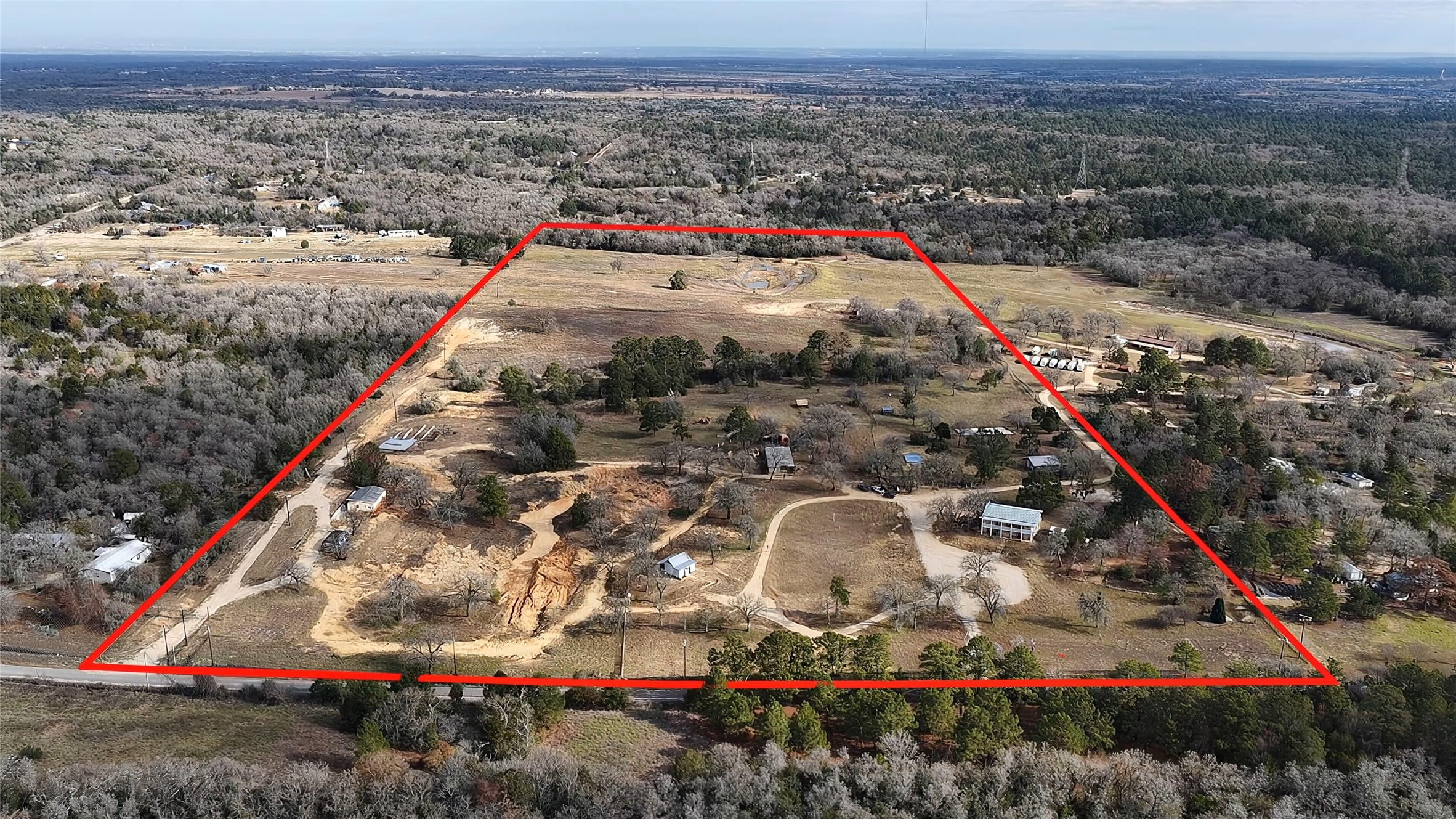 182 Little Ranch Road Red Rock, TX 78662 - Photo 3 of 40 Overview of rural landscape featuring a forest and property parcel outlined