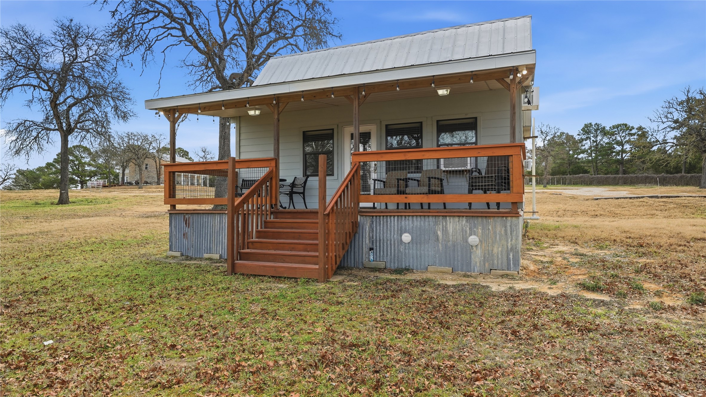 182 Little Ranch Road Red Rock, TX 78662 - Photo 35 of 40 View of front of house featuring a front lawn, a porch, and a metal roof