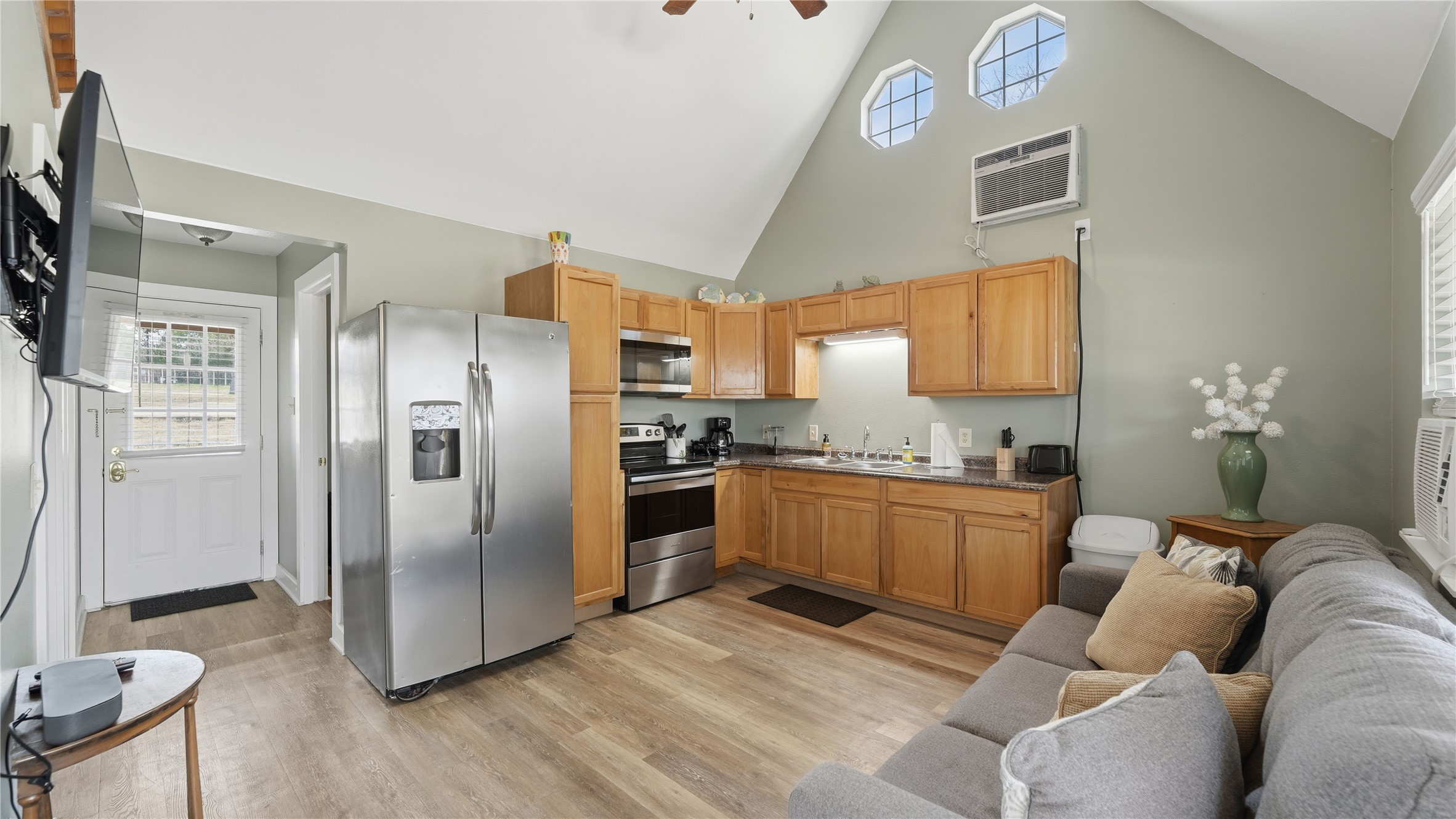 182 Little Ranch Road Red Rock, TX 78662 - Photo 38 of 40 Kitchen featuring stainless steel appliances, dark countertops, a high ceiling, light wood finished floors, and ceiling fan