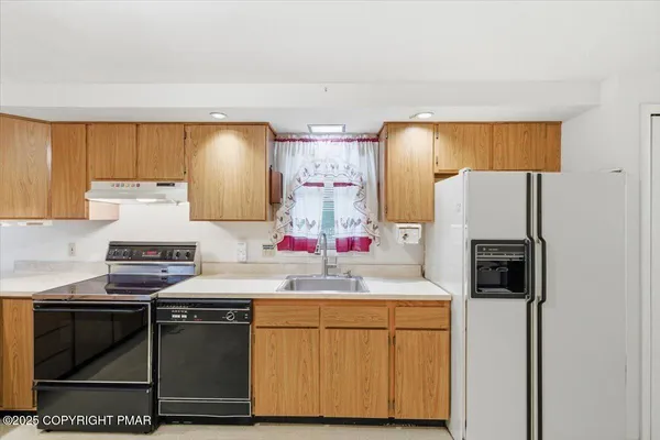 a kitchen with a sink and a refrigerator