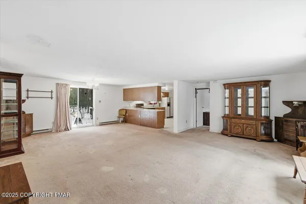 a large bedroom with a bed and furniture
