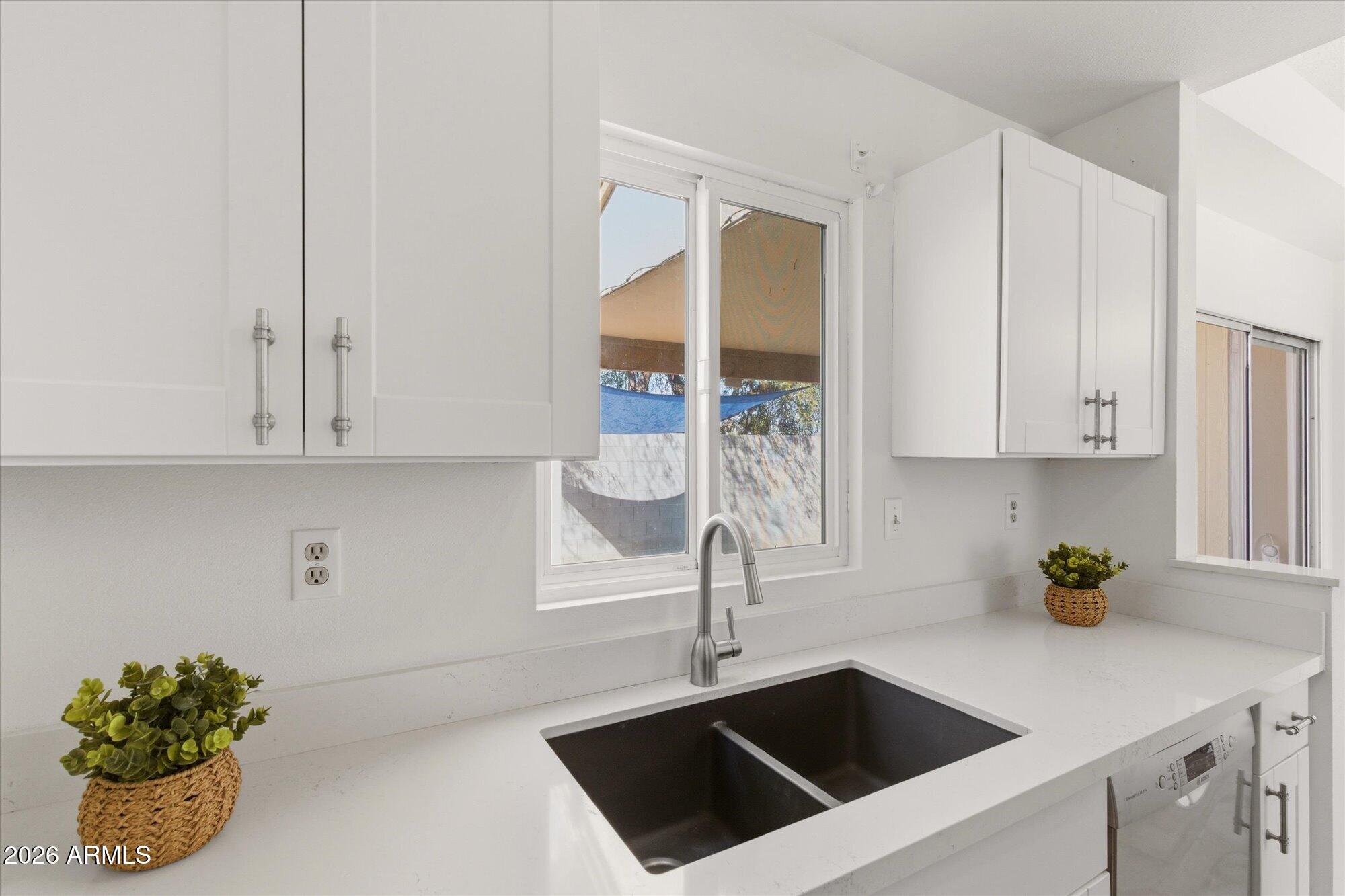 4208 East Carson Road Phoenix, AZ 85042 - Photo 11 of 25 a kitchen with a sink and cabinets