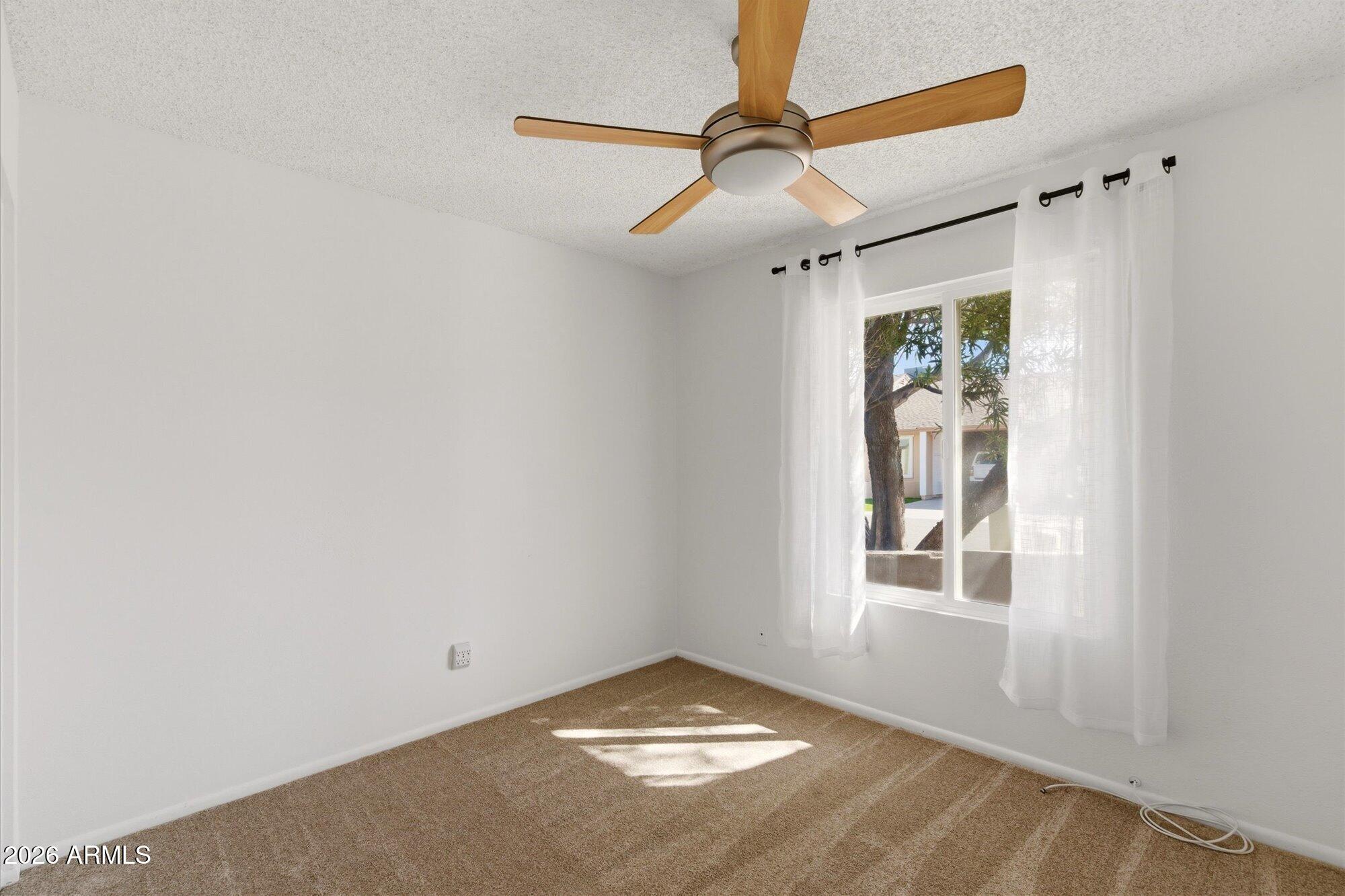 4208 East Carson Road Phoenix, AZ 85042 - Photo 18 of 25 an empty room with windows and fan
