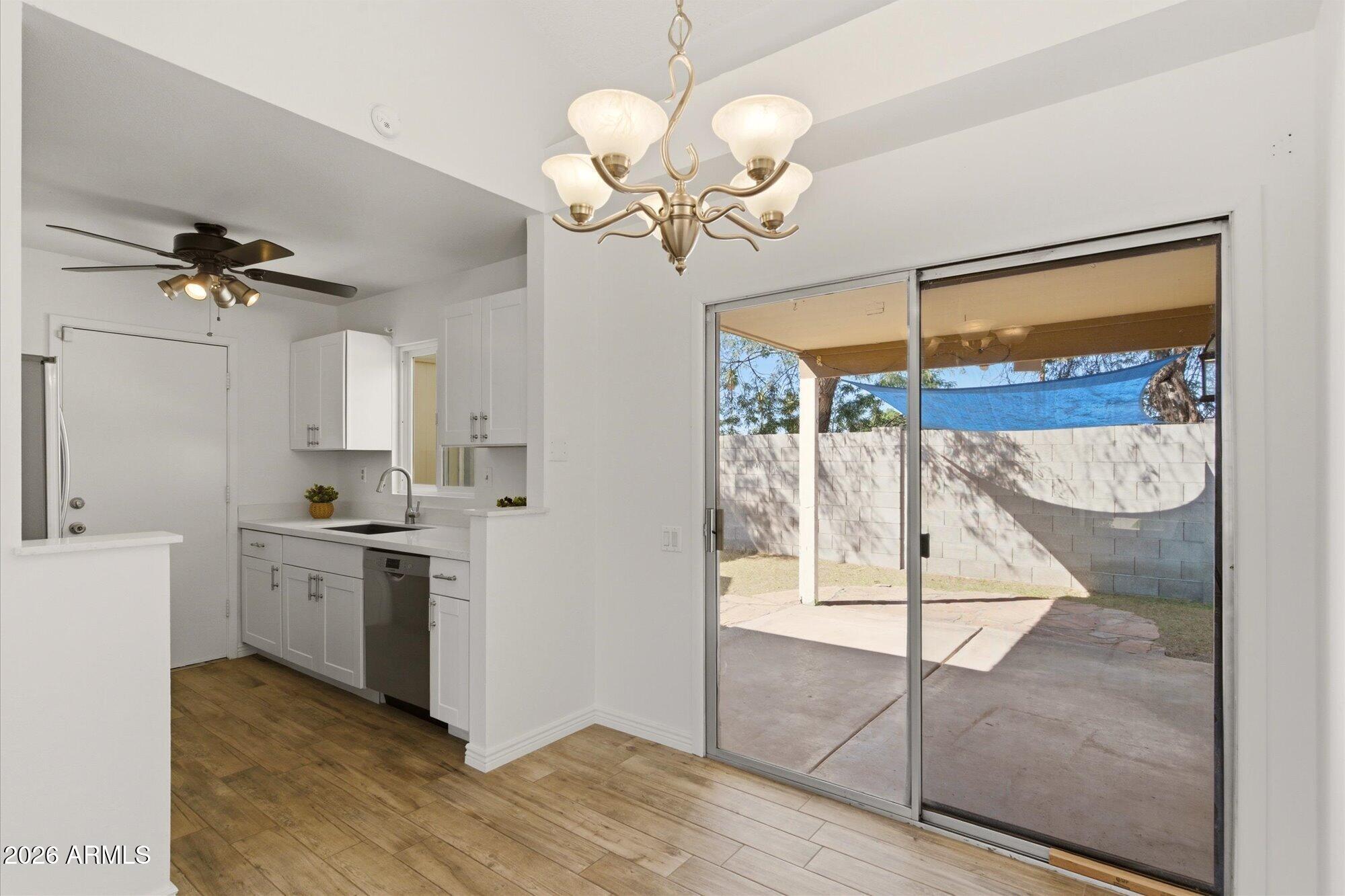 4208 East Carson Road Phoenix, AZ 85042 - Photo 8 of 25 a view of a kitchen with a sink cabinets and wooden floor