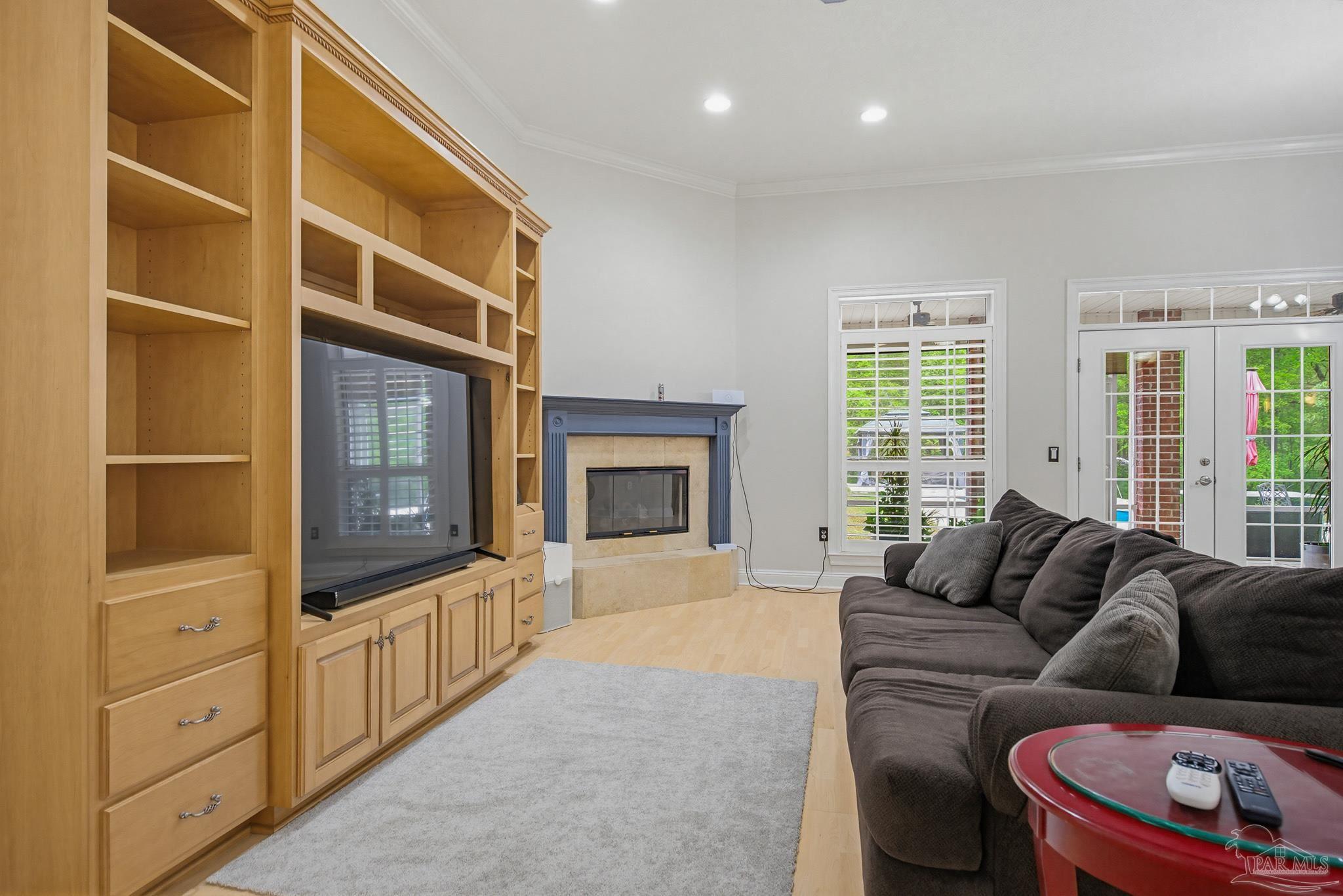 2855 Walling Road Milton, FL 32570 - Photo 17 of 55 a living room with furniture a flat screen tv and a fireplace