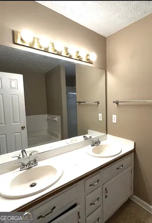 a bathroom with a double vanity sink and a mirror