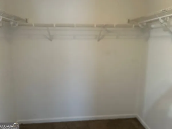 a view of a room with shelf with racks on the wall