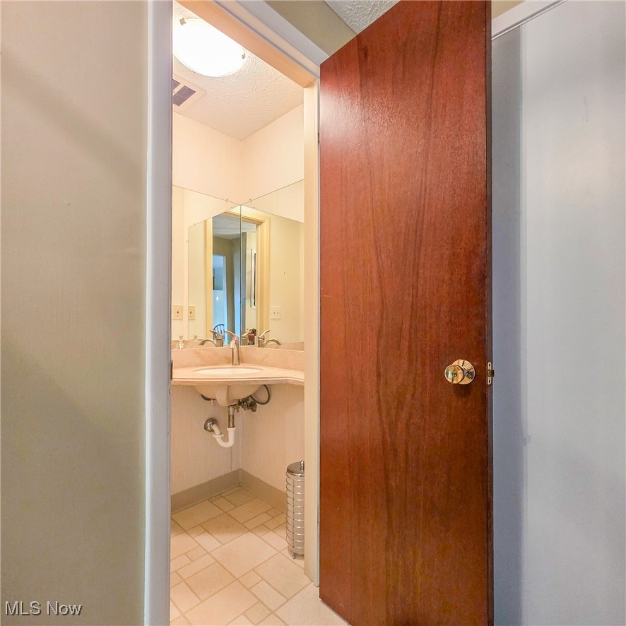 6474 State Road, Unit I10 Parma, OH 44134 - Photo 15 of 31 Bathroom featuring light tile patterned floors and a textured ceiling