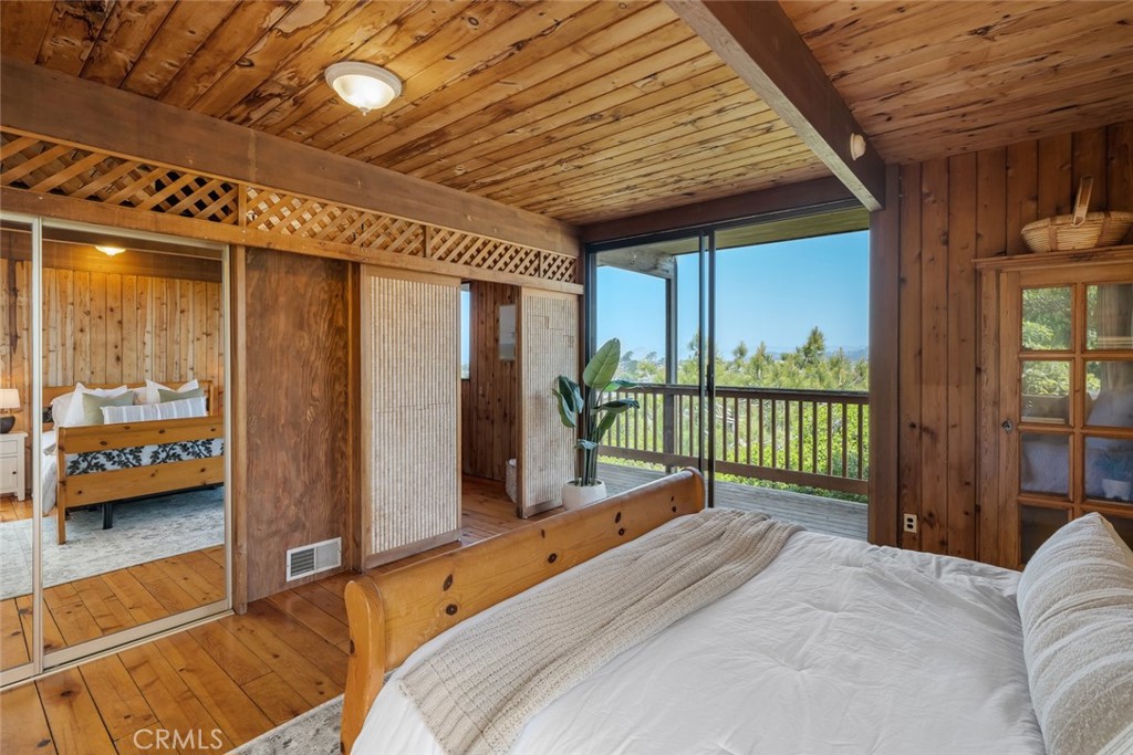 1515 9th Street Los Osos, CA 93402 - Photo 18 of 69 a bedroom with a bed and large window