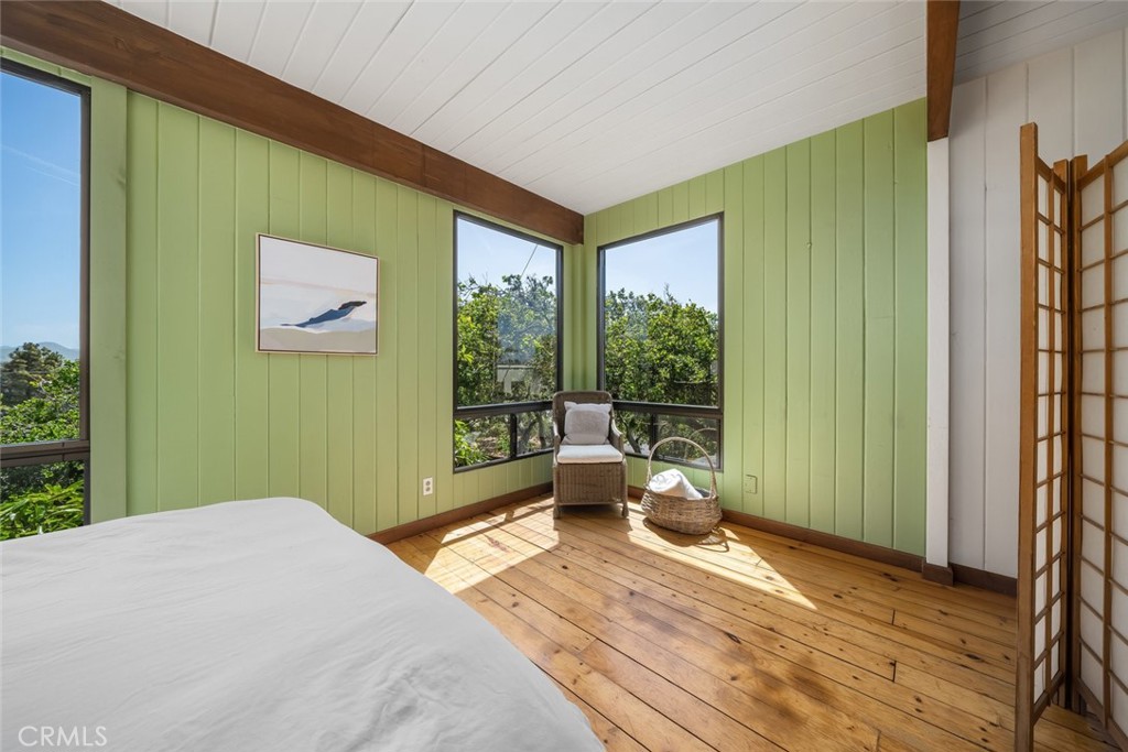 1515 9th Street Los Osos, CA 93402 - Photo 36 of 69 a bedroom with a bed and large windows