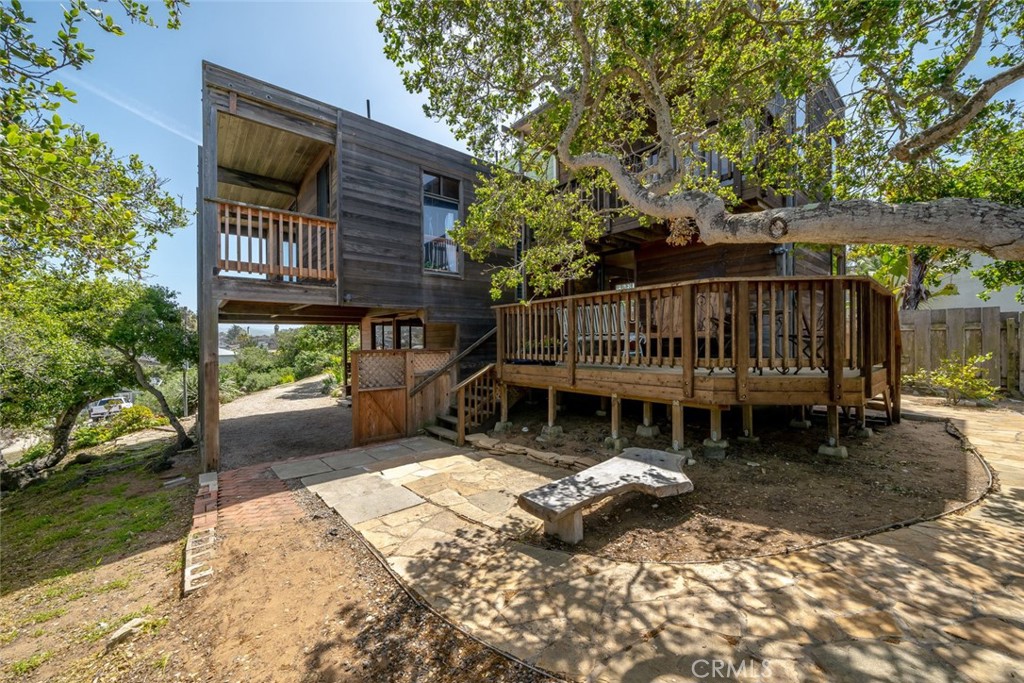 1515 9th Street Los Osos, CA 93402 - Photo 49 of 69 a view of a house with a wooden deck and a yard