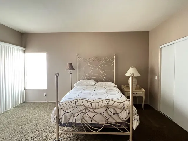 a bedroom with a bed and a table