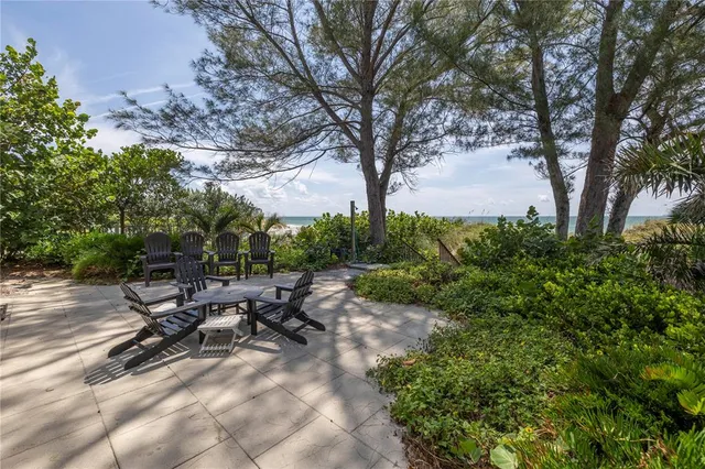 a bedroom with a bed a couch and two large window