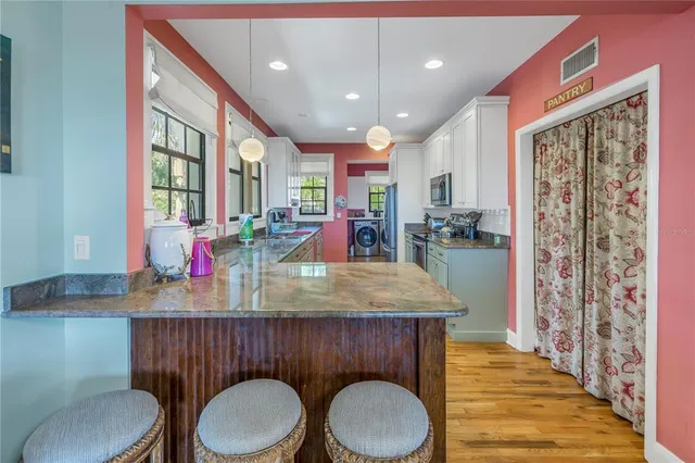 a view of backyard with plants and outdoor seating