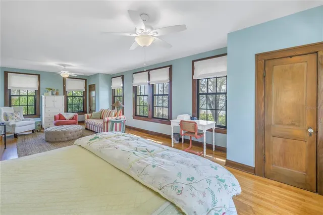 a bedroom with furniture a bed and a painting on the wall