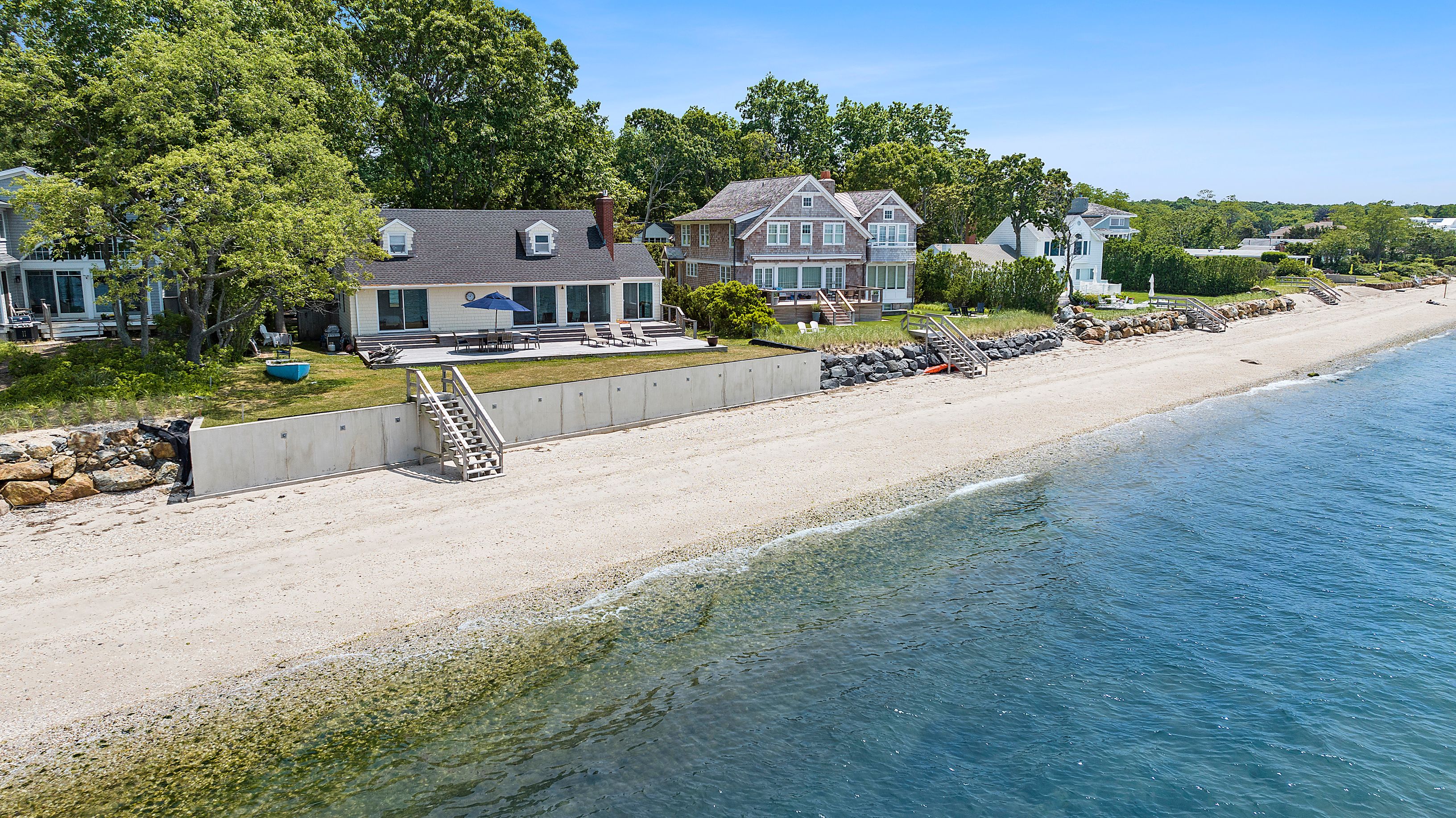 55 East Shore Road Southampton, NY 11968 - Photo 1 of 19 a front view of a house with a garden and a yard