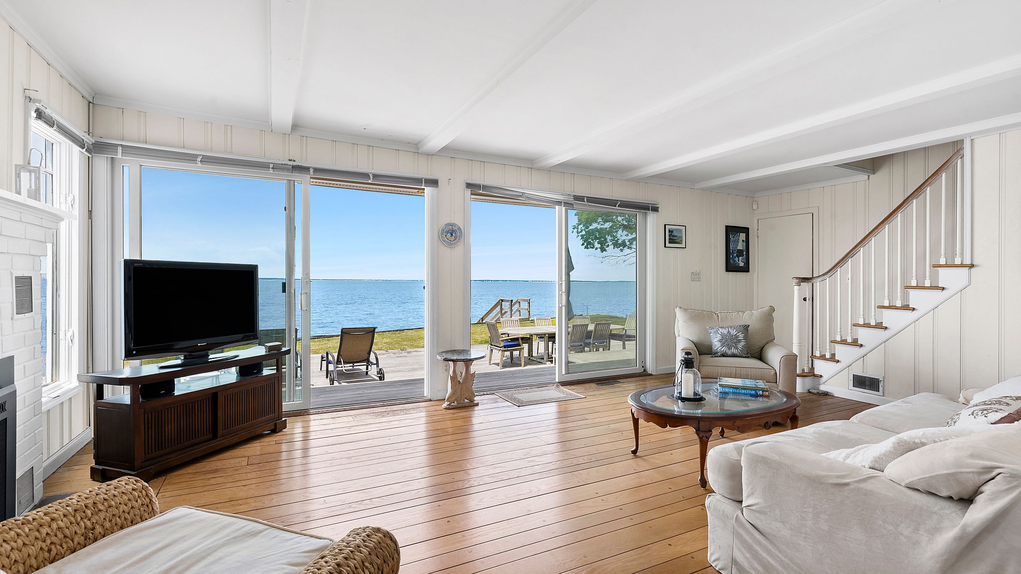 55 East Shore Road Southampton, NY 11968 - Photo 8 of 19 a living room with furniture and a flat screen tv
