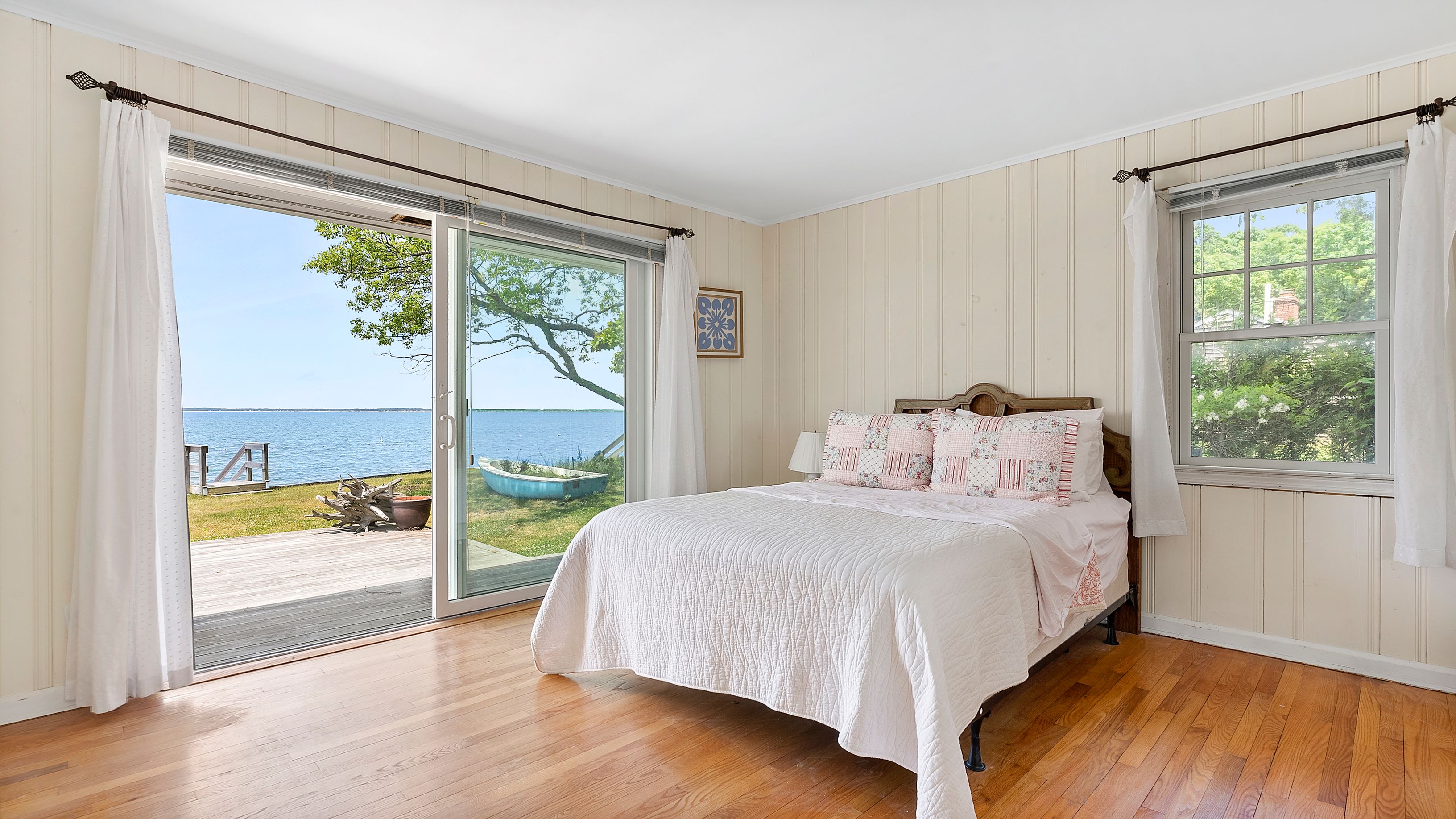 55 East Shore Road Southampton, NY 11968 - Photo 10 of 19 a bedroom with a bed and a large window