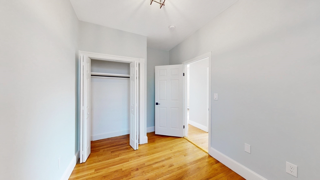 181 Highland Street, Unit 1 Boston, MA 02119 - Photo 8 of 11 a view of an empty room and window