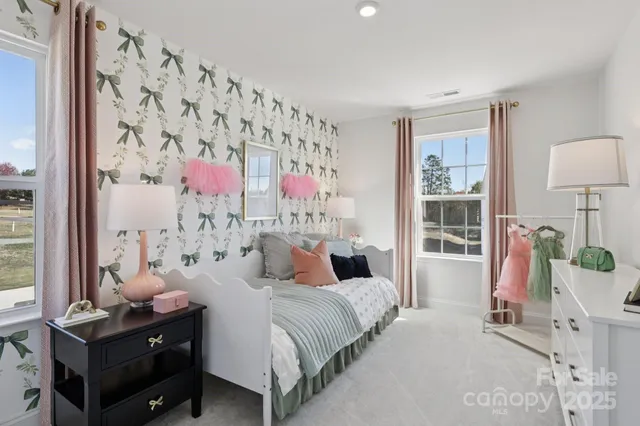 a bedroom with a bed and large window