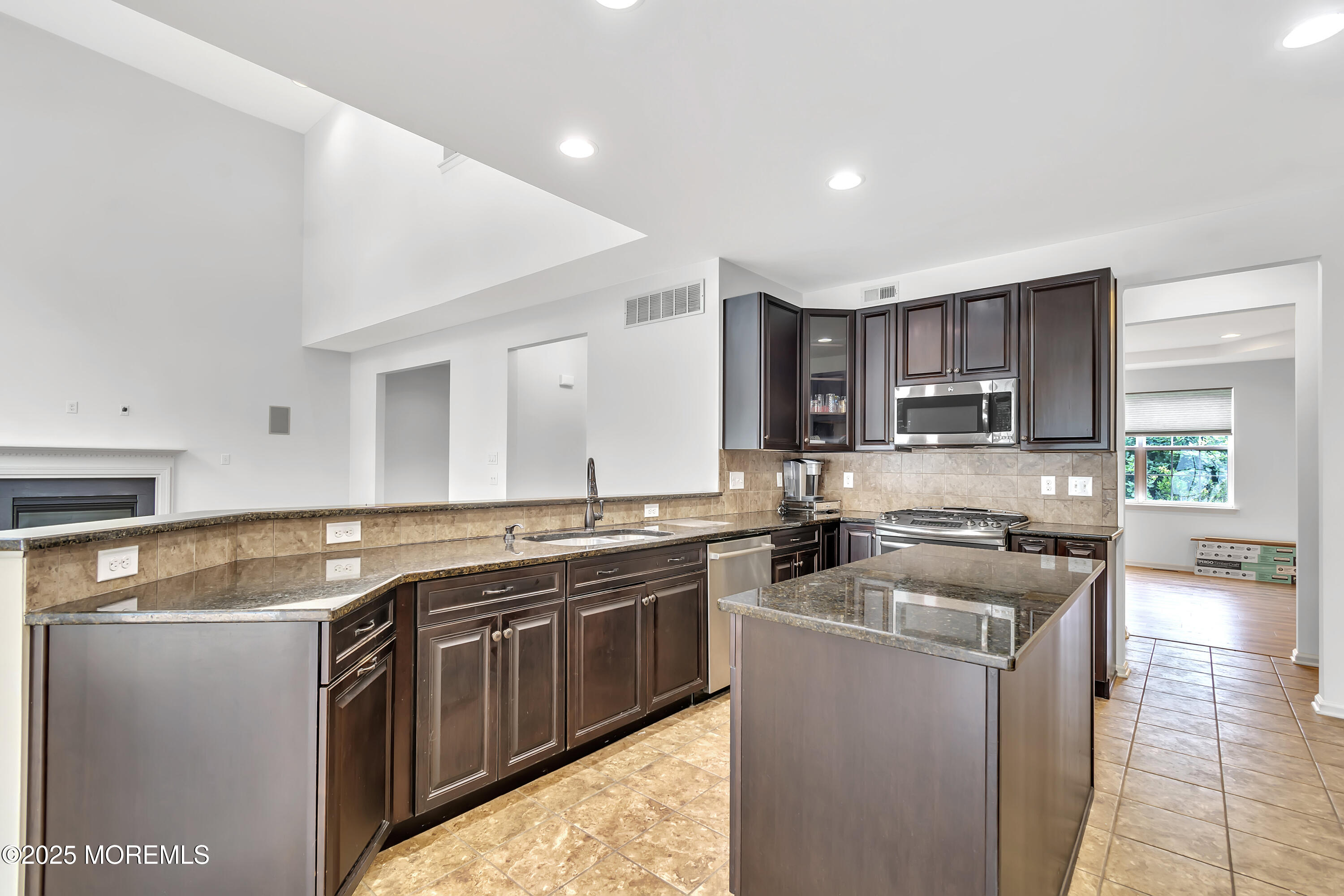 4 Christopher Drive Howell, NJ 07731 - Photo 31 of 41 a kitchen with stainless steel appliances granite countertop a stove a sink and a microwave