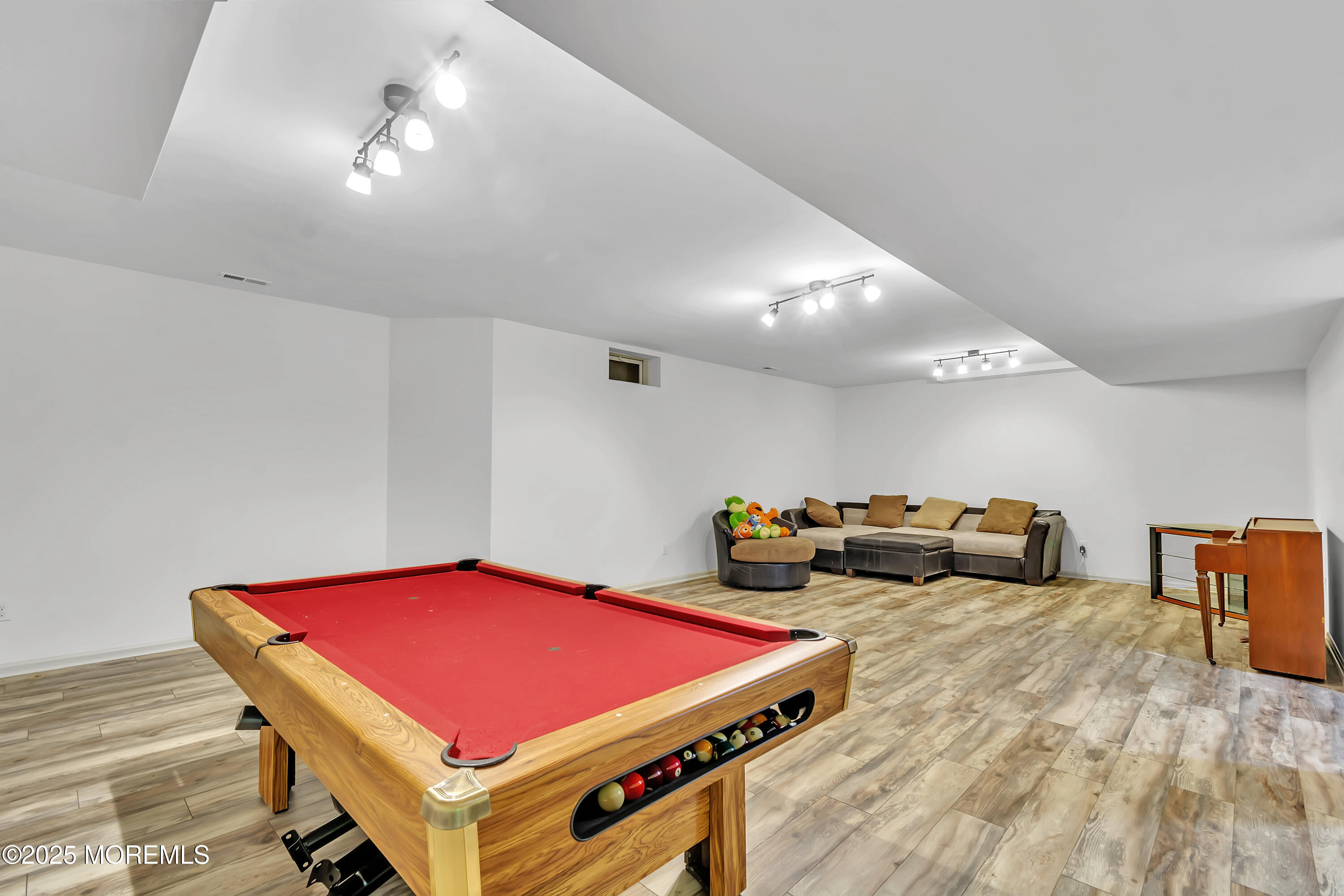 4 Christopher Drive Howell, NJ 07731 - Photo 4 of 41 a room with gym equipment and a chandelier