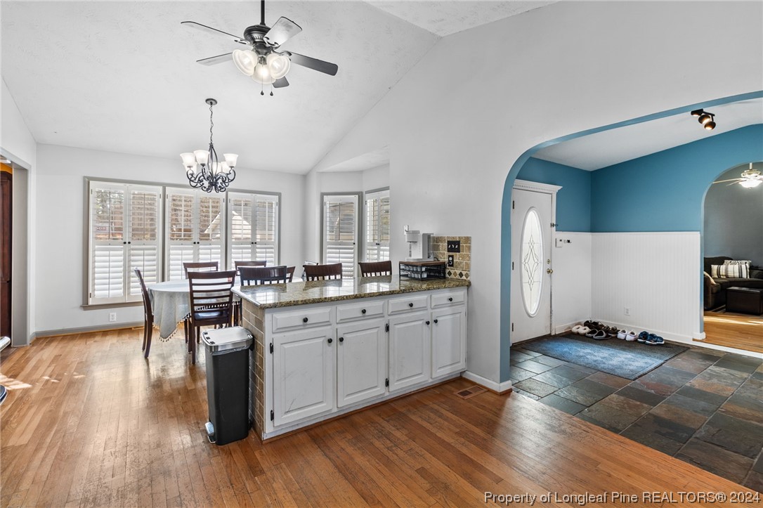 1177 Palestine Road Linden, NC 28356 - Photo 12 of 46 a open kitchen with stainless steel appliances granite countertop a stove dining table chairs and a large window